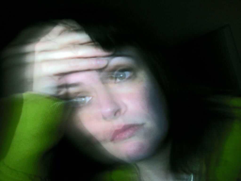 distressed woman caucasian woman with a forlorn look and hand on her forehead