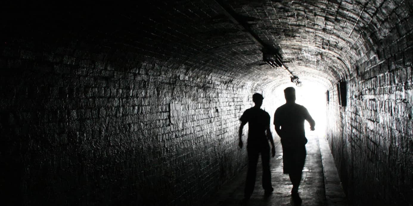 tunnel two people walking down a tunnel.
