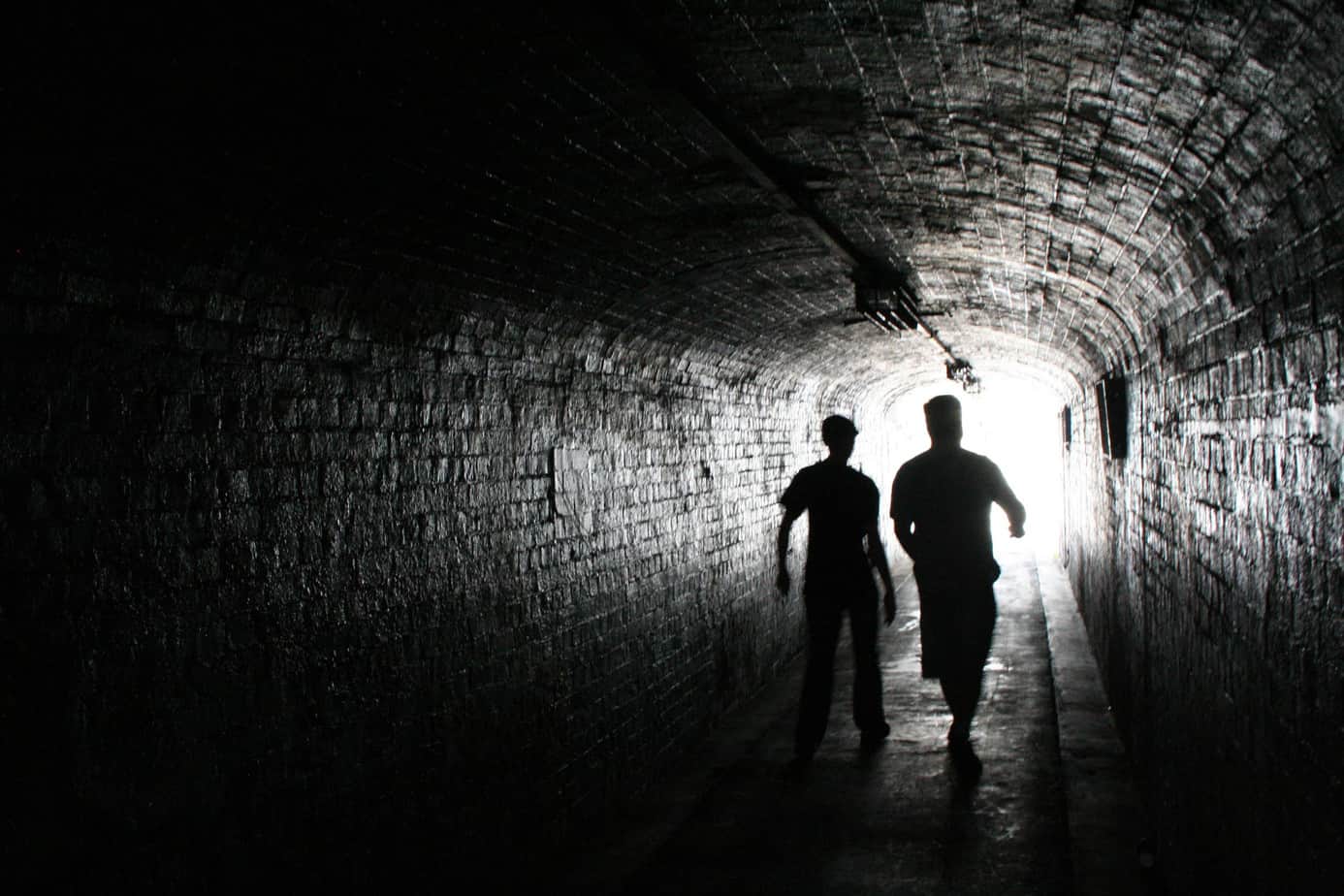 tunnel two people walking down a tunnel.