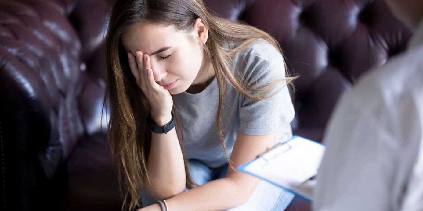 Unhappy young girl at the psychologist, doctor healing after suicide loss