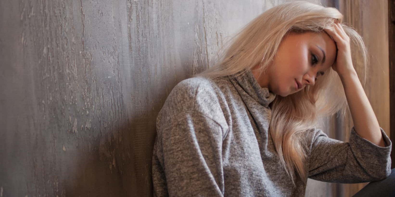 Depressed woman. blonde girl sitting on the floor, sadness and depression woman dealing with depression