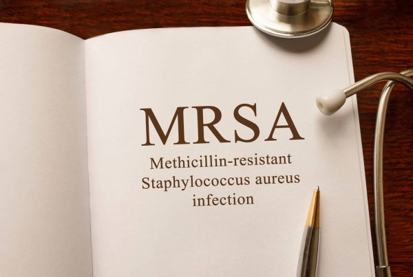 Page with MRSA Methicillin-resistant Staphylococcus aureus infection on the table with stethoscope, medical concept book on MRSA | Eco Bear