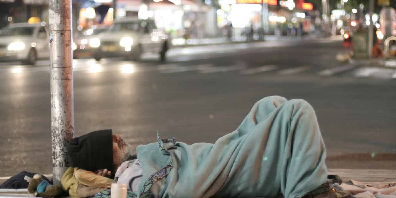Male homeless sleeping in a street homeless man