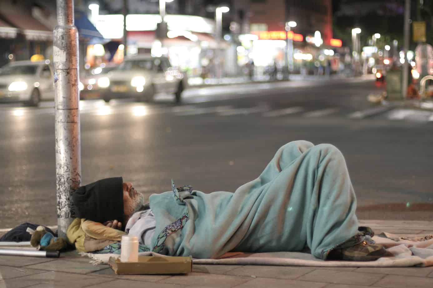 Male homeless sleeping in a street homeless man
